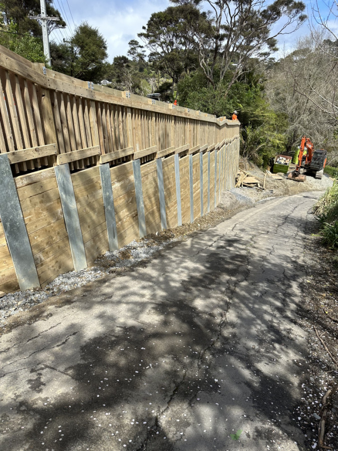 Steel I beam retaining wall plus handrail on top to follow gradient of road , works done for AT