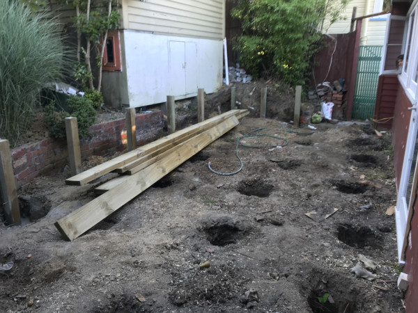 Retaining posts in, deck post holes dug