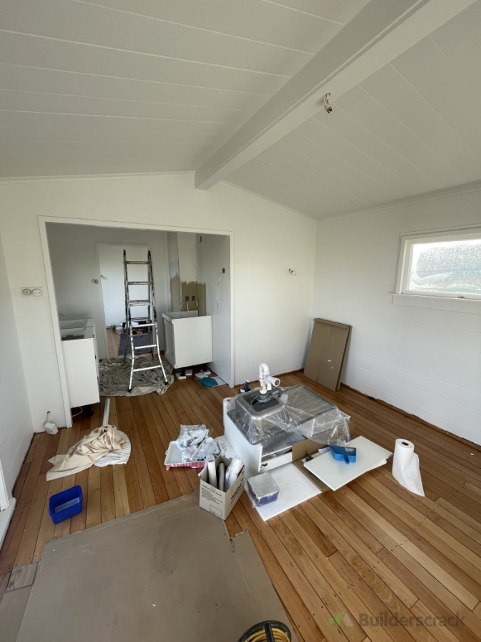 Walls up, painted, kitchen half in and floor sanded