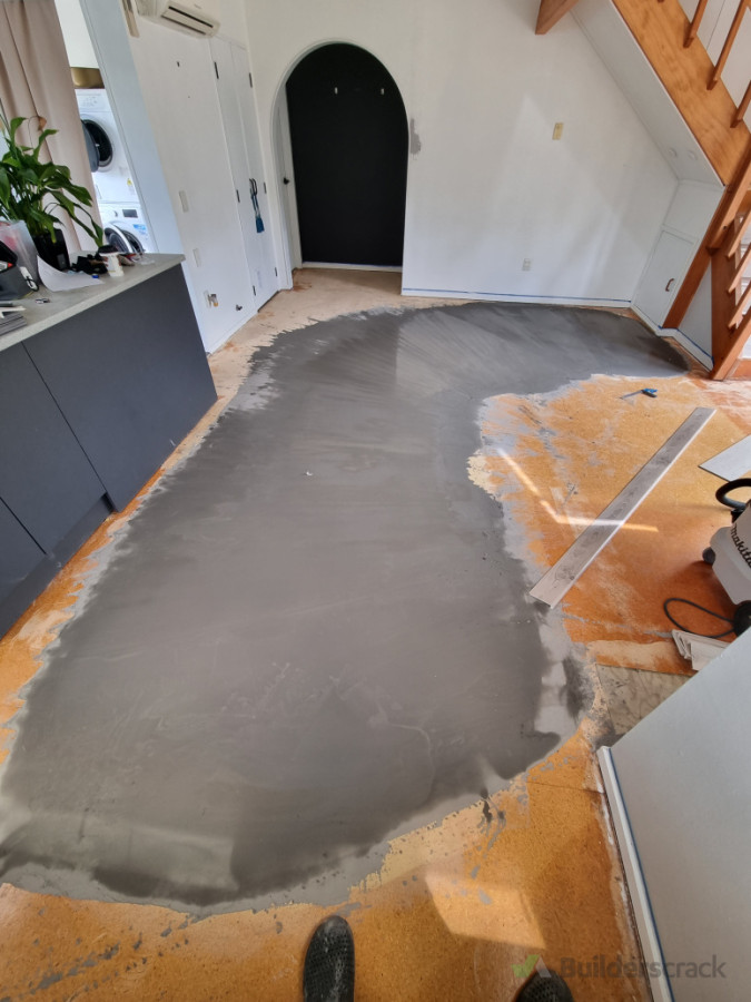 Adding levelling compound to remove the large dip in the room