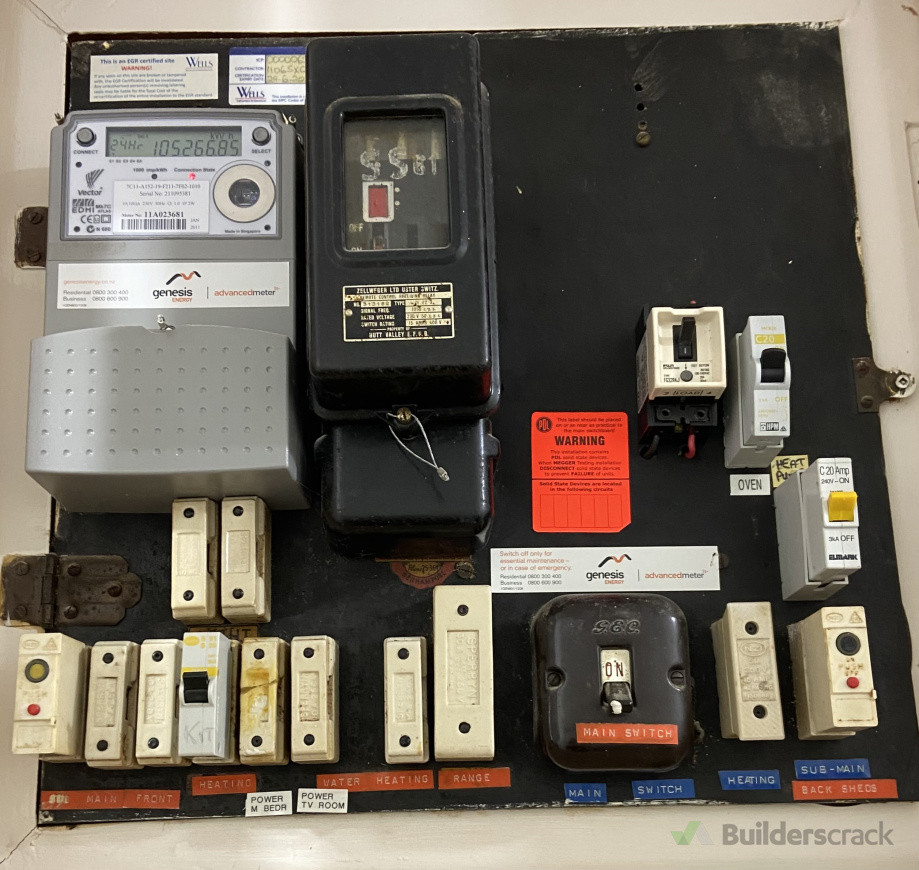 (1. Before) Old switchboard, with all ceramic fuses and old asbestos panel.