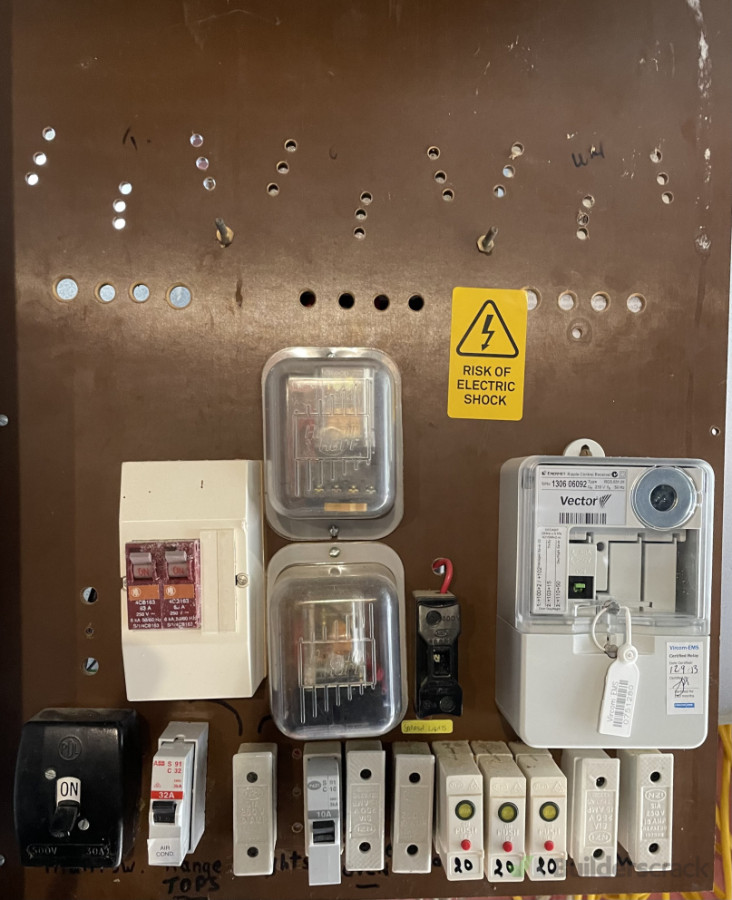 (2. Before) old switchboard with brittle ceramic fuses and no shock protection.