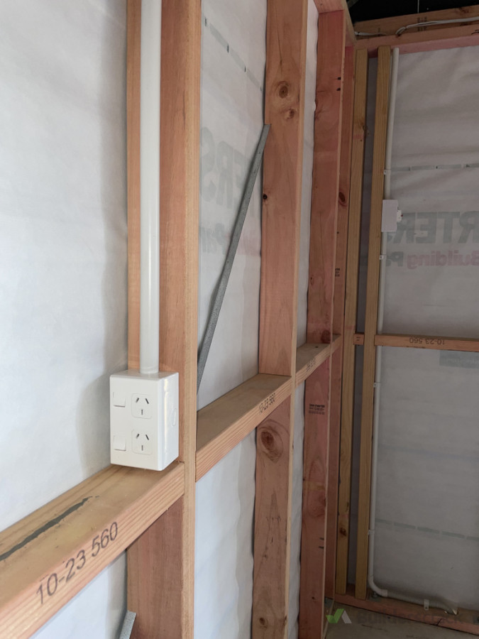 Unlined garage fit out, all cabling clipped above and all protected in conduit.