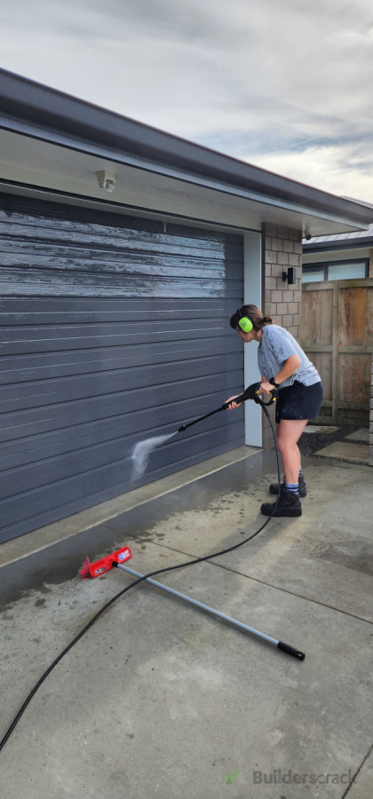 Pressure washing walls.