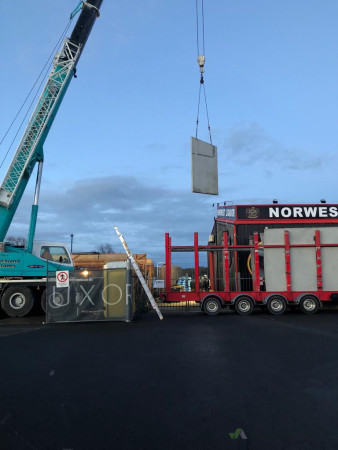 Crane placing tilt slab panels to new building
