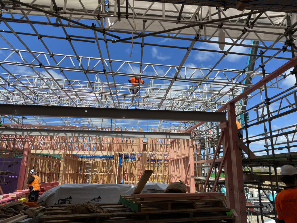 Applying shrink wrap to temporary roof structure