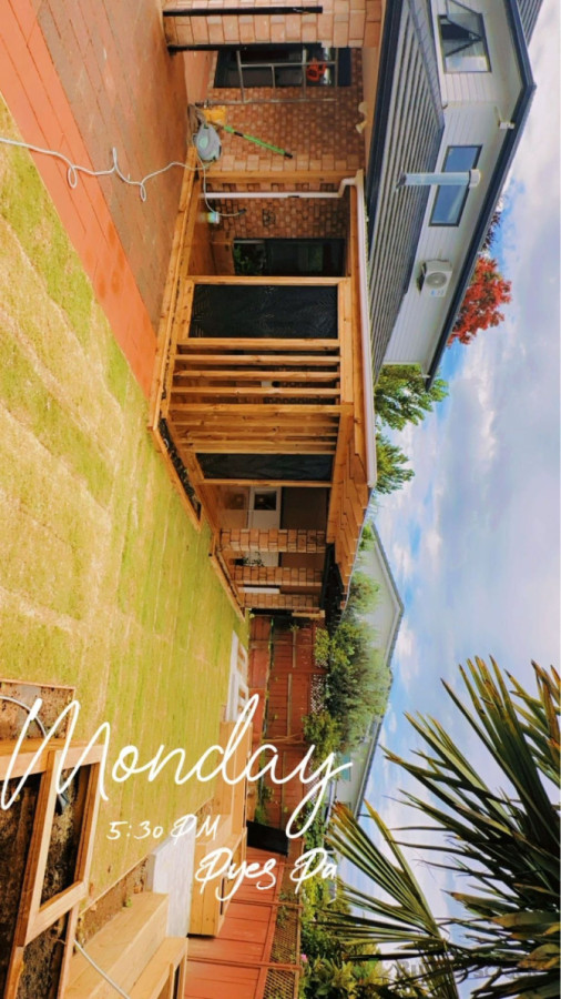 Extensions —- Pavers, decking , pargola , garden box with sitting chairs, concrete, grass .
