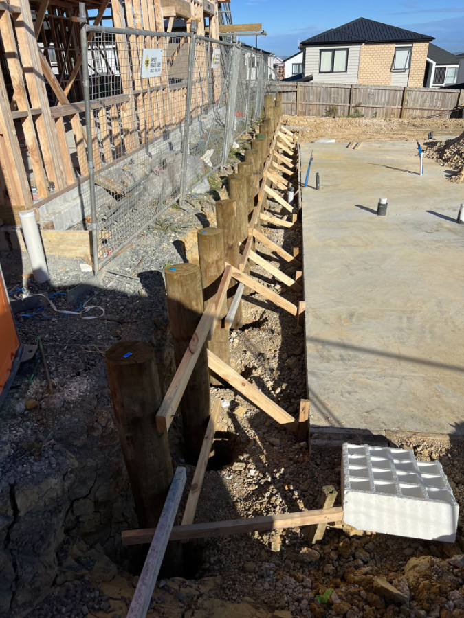 Framing being Carried out on one house and RT Wall being Built on the other