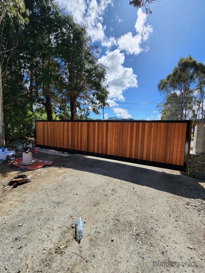 Cedar slats installed on a steel electric gate