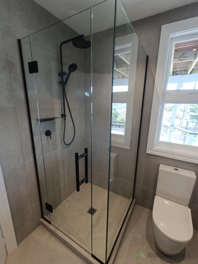 Frameless shower using Matt black hardware and channel