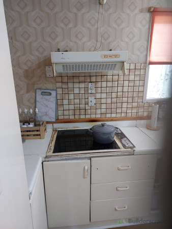 Beforehand photo, with switches just behind cooktop not complying to regulations