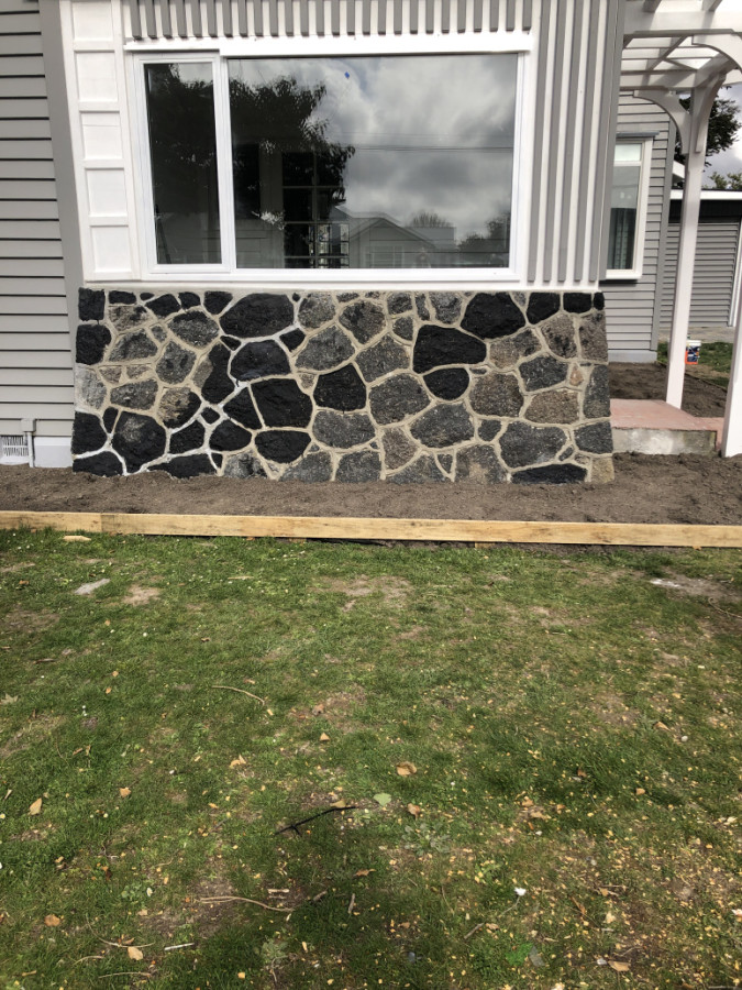 vertical  cladding design and original  stone  reapirs