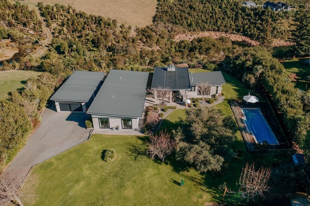 Aerial view of garage extension (left) and pool addition (right)