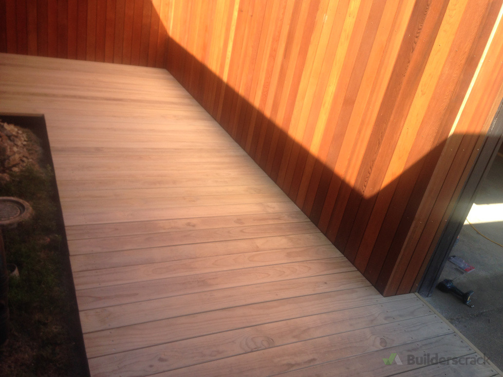 Cedar wall and decked entrance to front door .