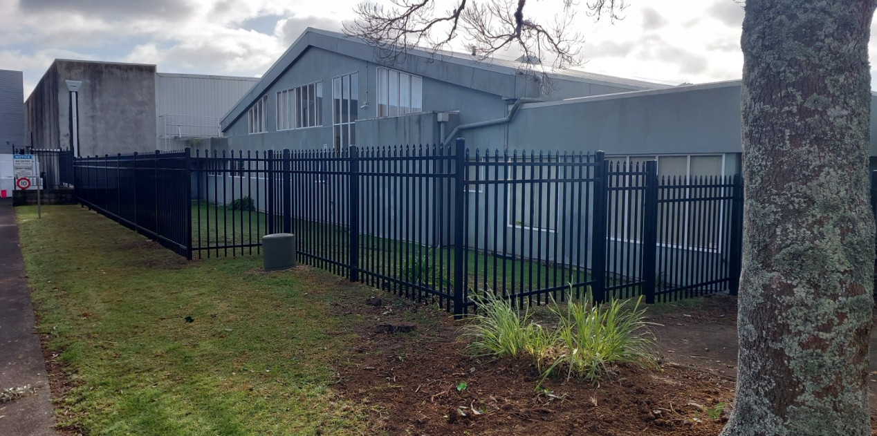 Spare top aluminum fencing with a custom pedestrian gate.
