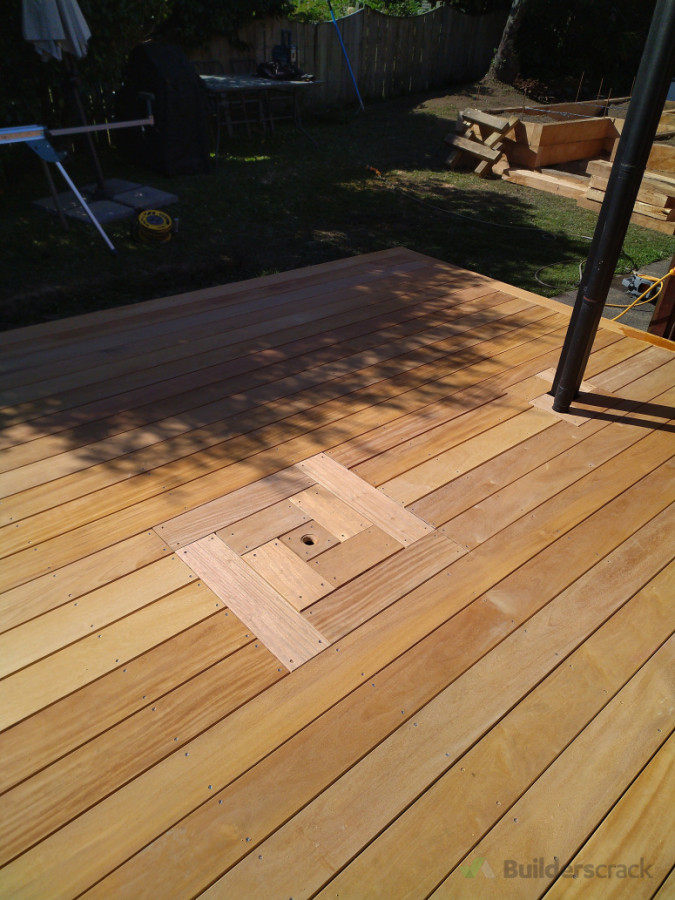 Garapa decking, with small removal centre peice to access the existing drainage system