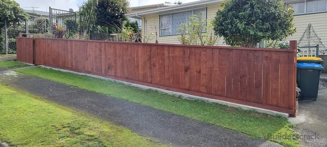 Stained paling fence.