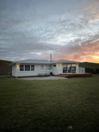 House exterior sanded, preped and painted, new ranch slider installed, decking installed, new feature lighting