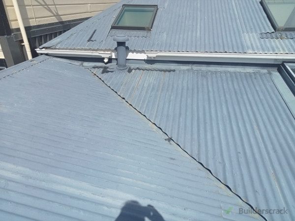 Before - rain was visible internally. Rain was being driven through roof valley flashing causing the interior structural beam to rot.