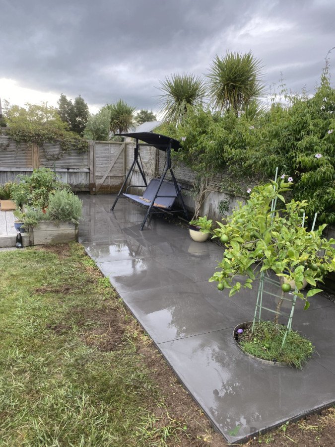 Concrete pad with 1m x 1m cuts and river stone strip for run off