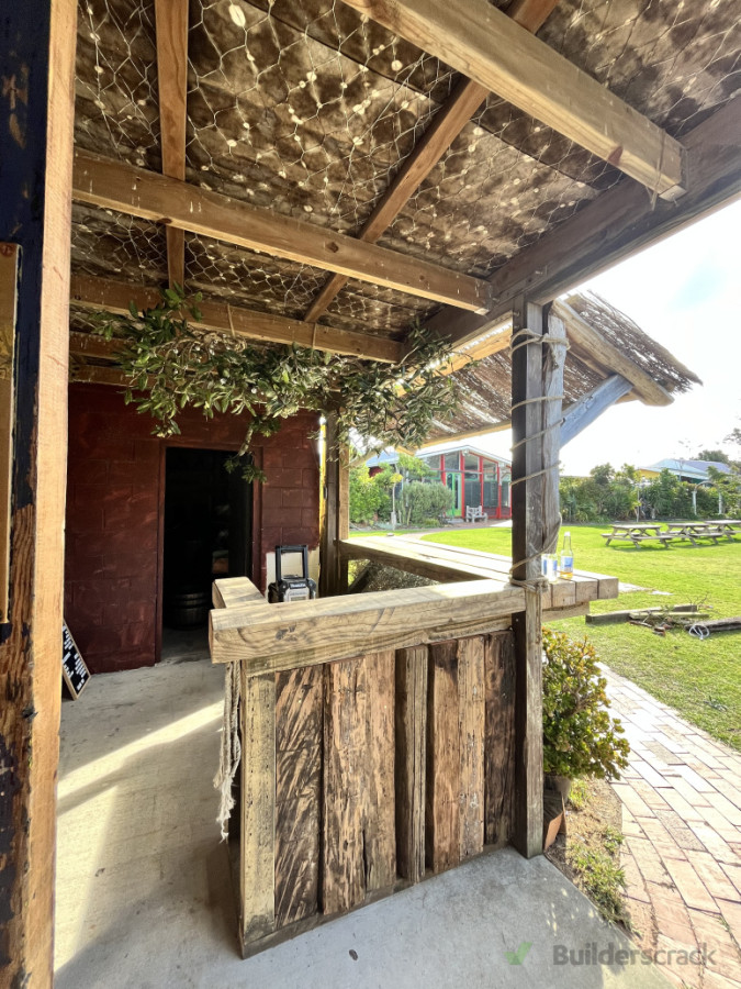 Rustic bar from timber laying around the farm.