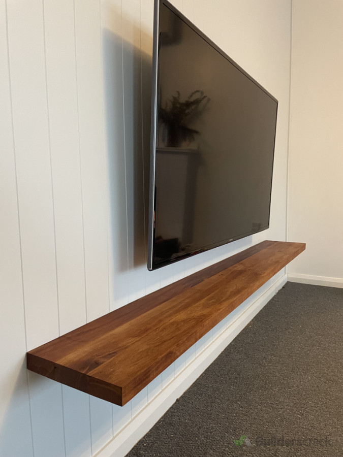 Recycled rimu framing used as a floating shelf under a tv