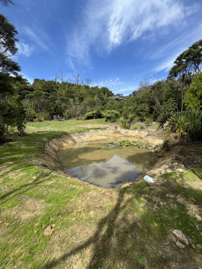 grass established and overflow in, spillway to the left of pipe