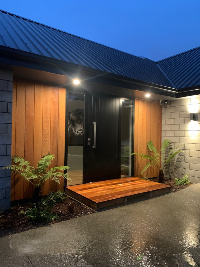 A statement entrance with a kwila deck & native planting.