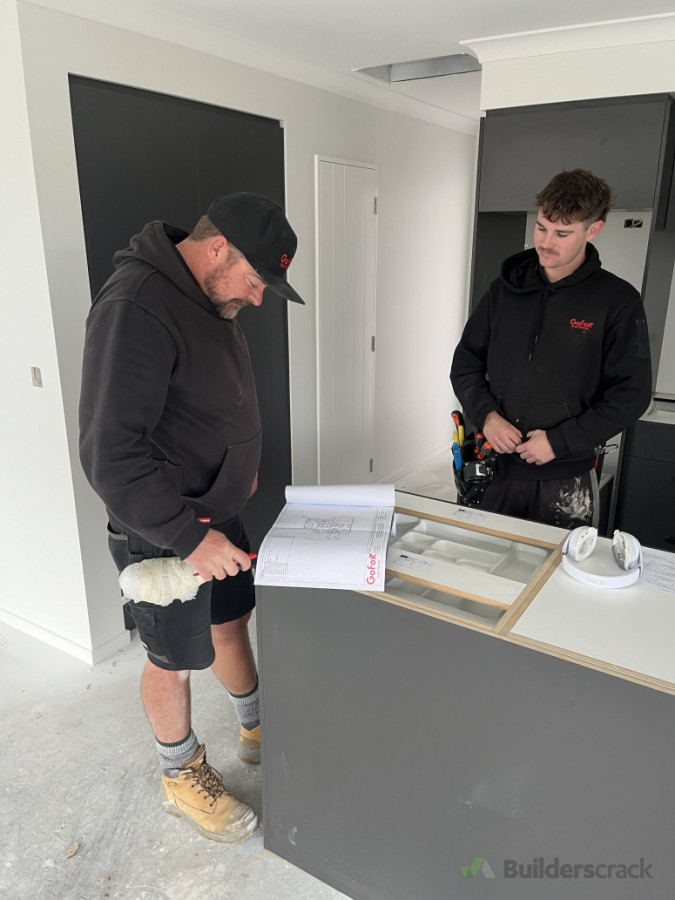 Joe and Samson reviewing plans