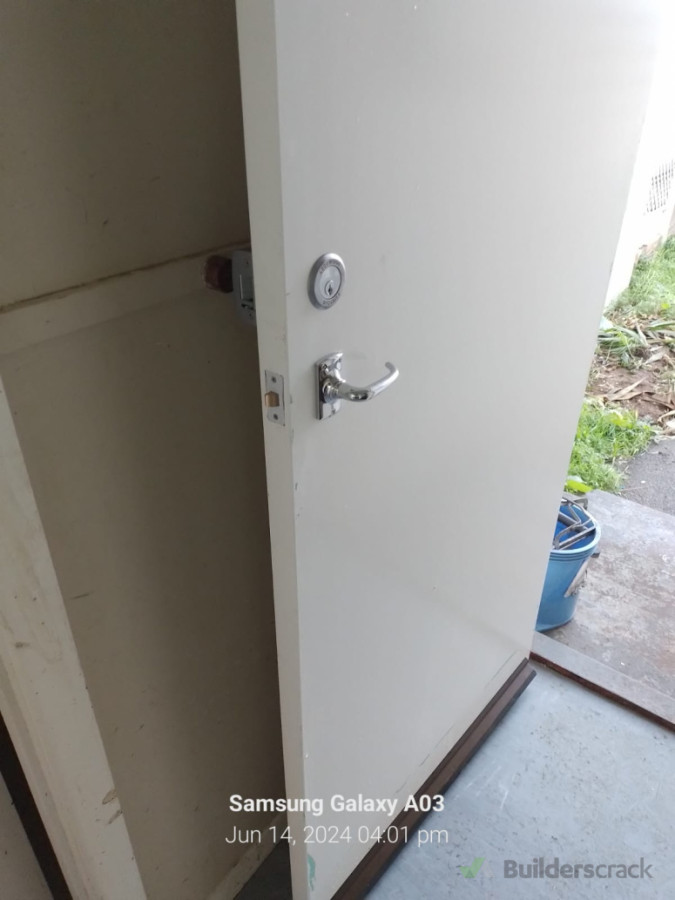 Exterior solid core door and locks installed