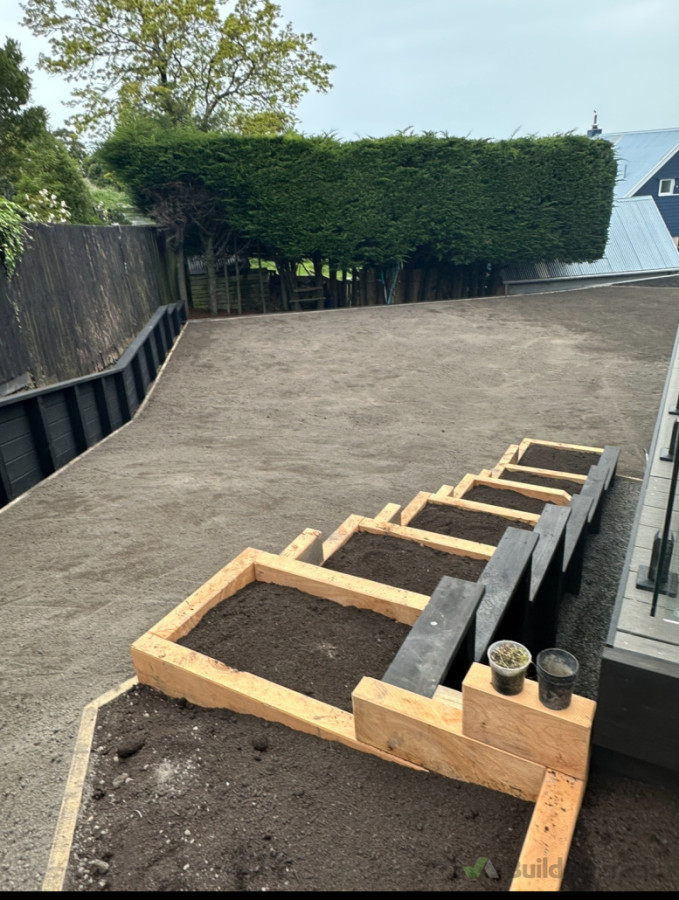 Macrocarpa planter boxes, retaining wall and lawn prepped of hydroseed