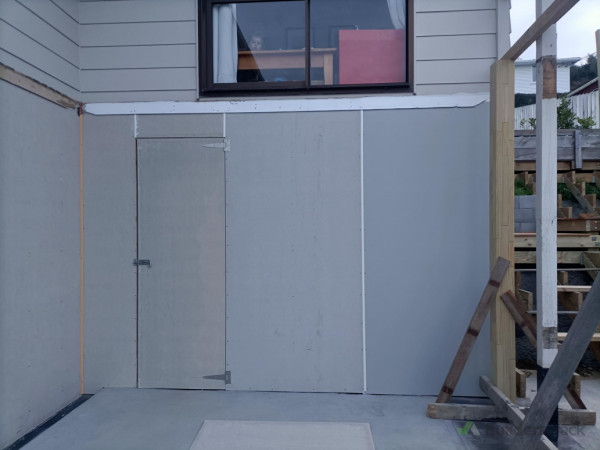 After - new cladding installed, building tape applied to protect existing framing