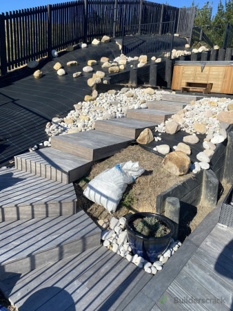 The client had left over material from their first deck which I was able to use to build a nice staircase up to the spa. Clients put in some hard work to weed mat the surround and put in some nice plants and stone