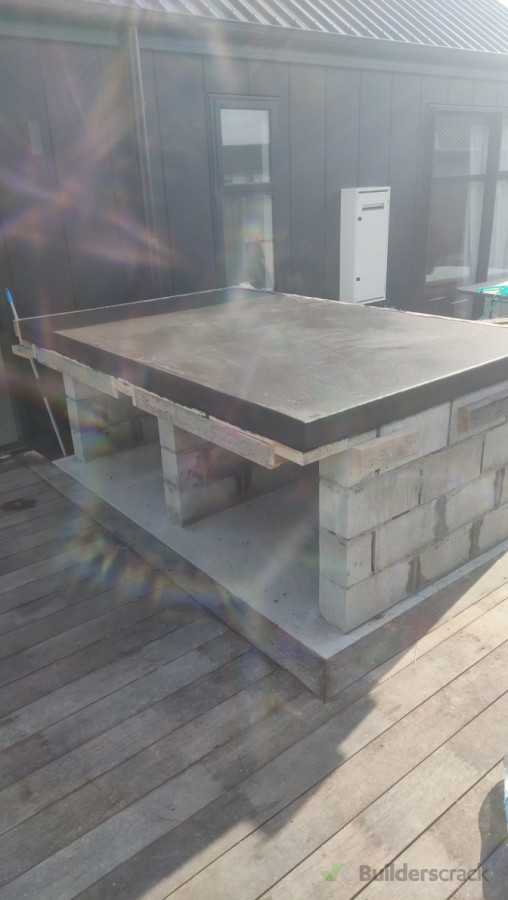 Black oxide concrete bench top for a braai .