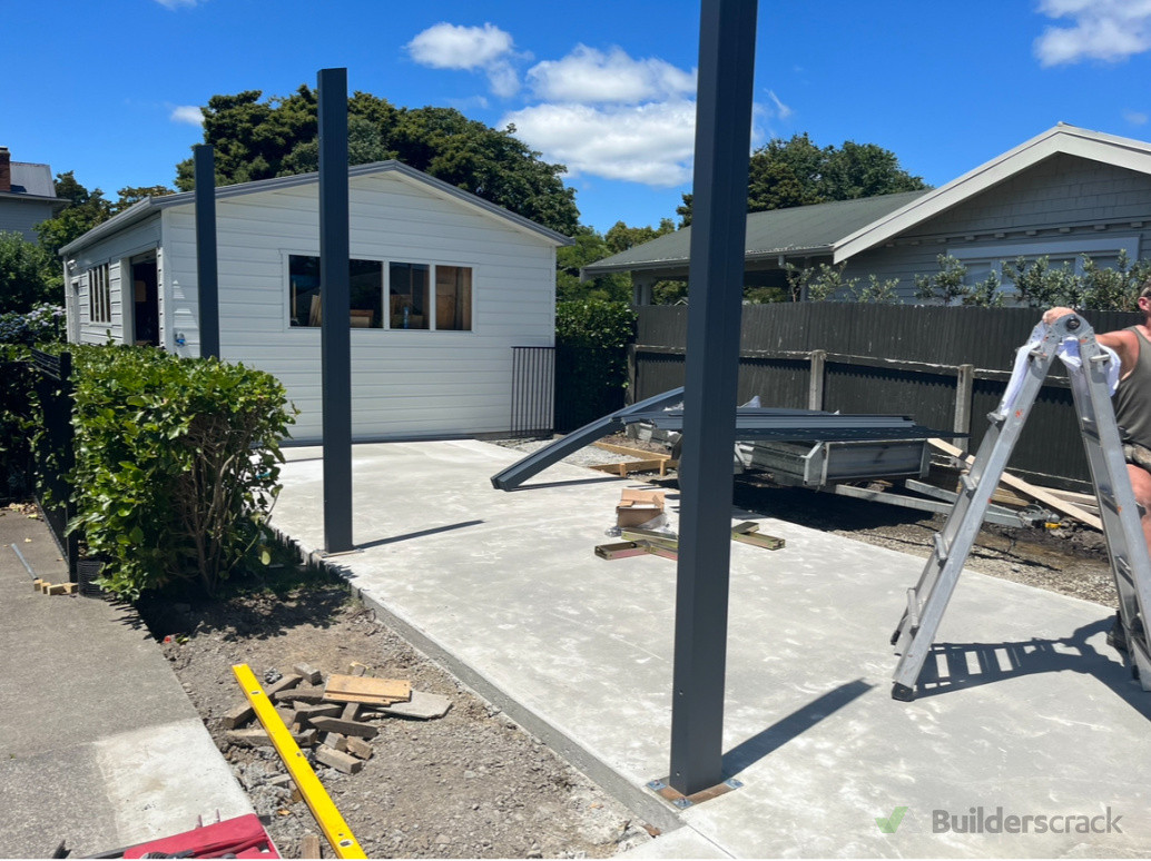 Foundation Setup: Initial stages of the carport installation, with foundational poles securely in place, laying the groundwork for a robust and long-lasting structure.