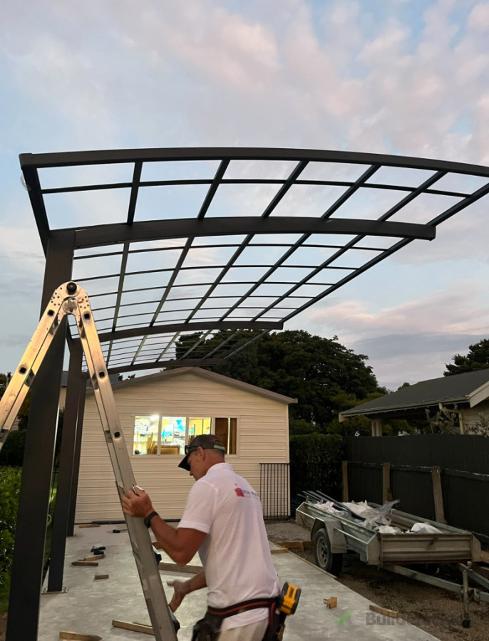 Frame Assembly: The team assembling the sturdy steel frame of the carport, ensuring precision and stability in every aspect of the structure.