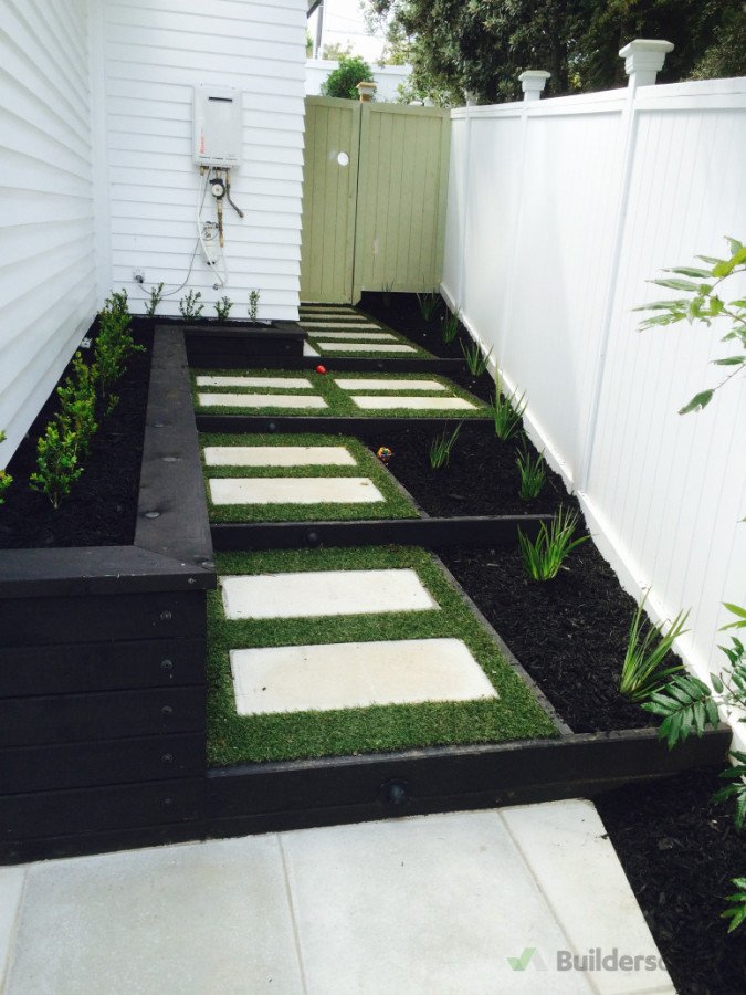 New timber fence, planters, stepping stones surrounded by tiger turf and planting