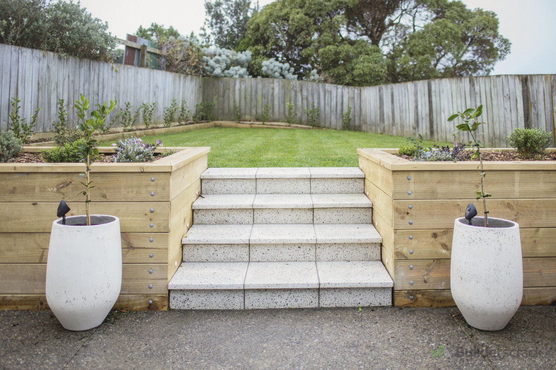 Simple and accessible backyard, easy  access raised planters filled with edible veges and herbs