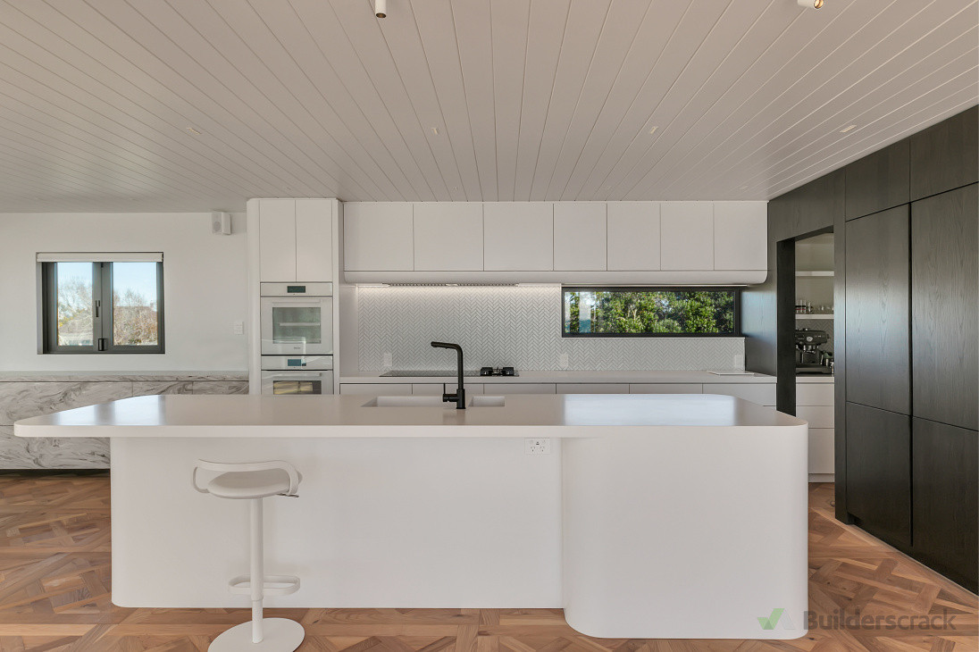 New kitchen with unique panelling and parquet flooring