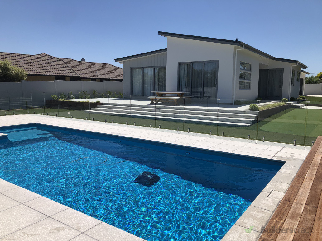 After photo of complete landscape project. Pool, House patio with paved steps and turf lawn with putting green