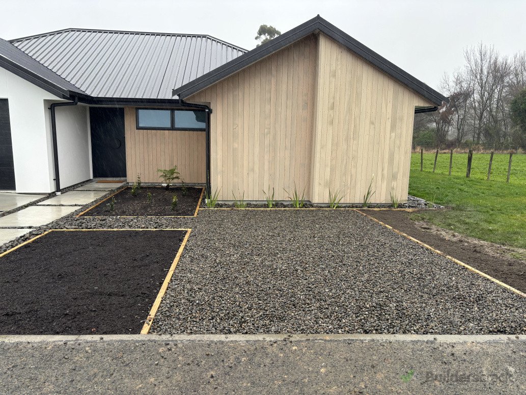 Simple extra parking area with permeable pavers under gravel and garden beds for the homeowner to plan out