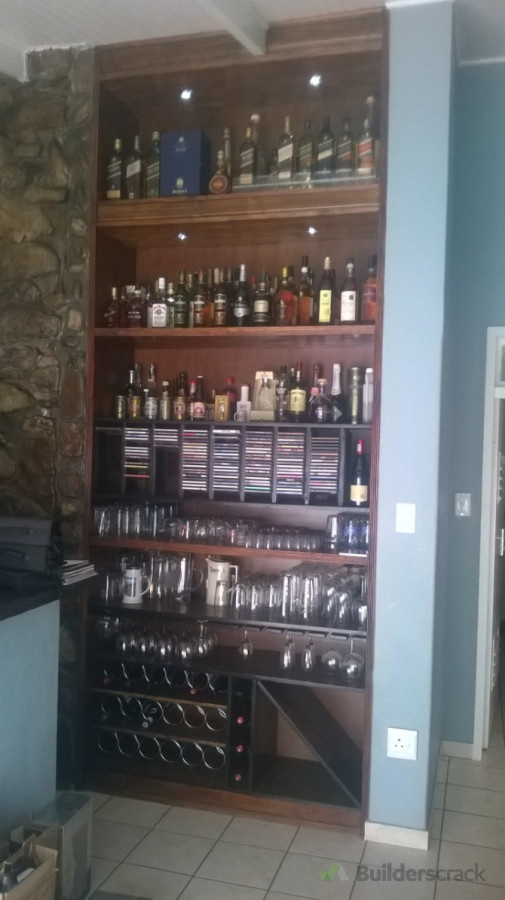 Design, built and installed bar cabinet in wall cavity