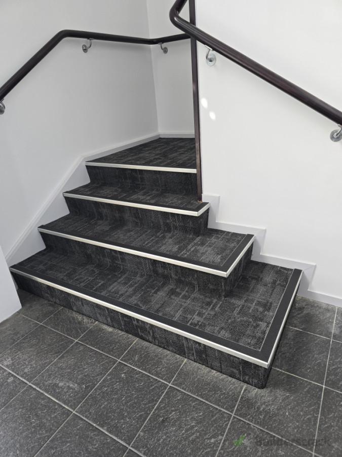 Carpet tiles to staircase.