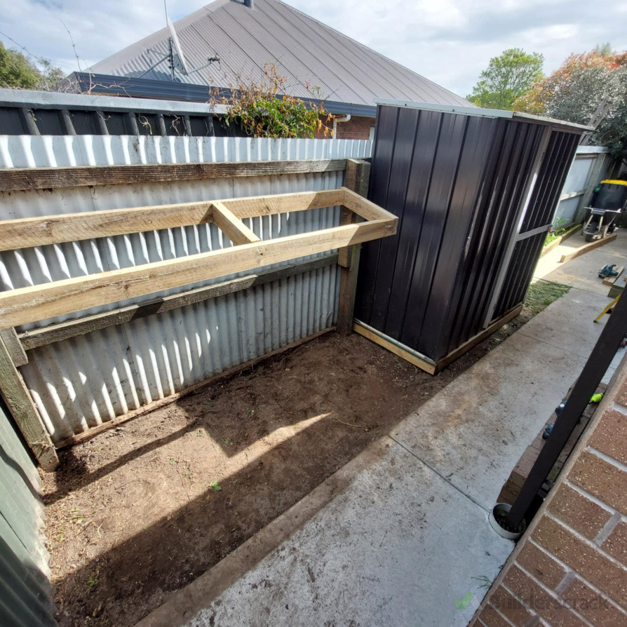 Garden shed installed and small pitched shelter framed.