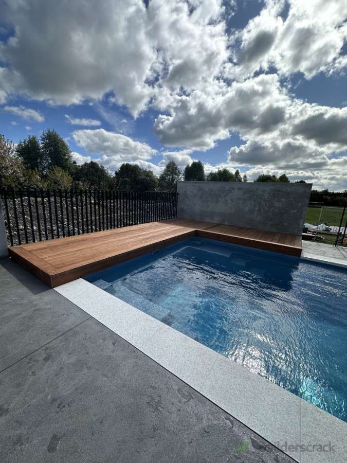 Hidden pool cover under Kwila deck, Block walls plastered, Aluminum and glass pool fencing