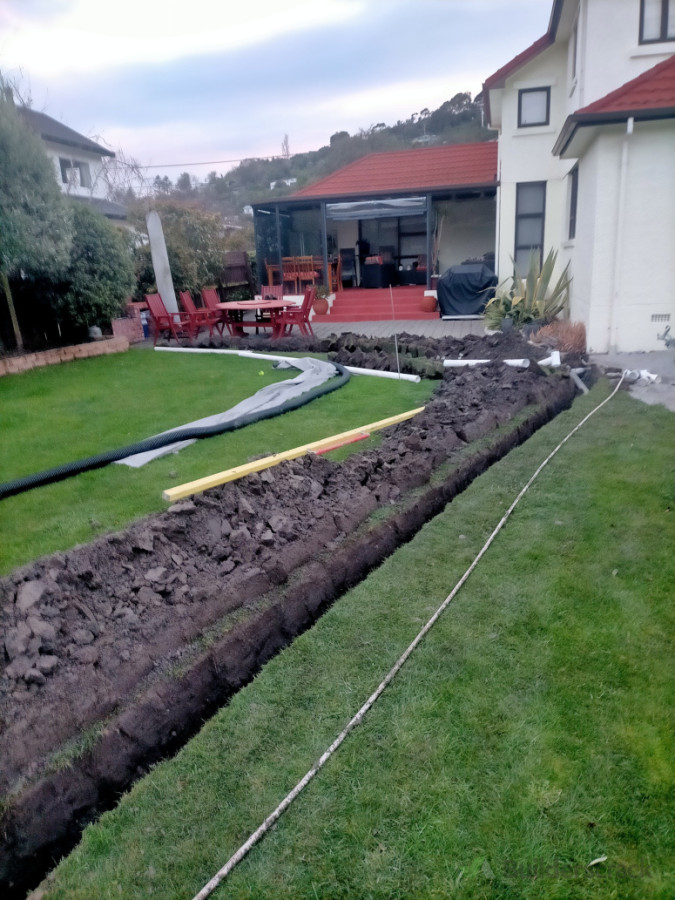 Install drainage and soak pit, reinstate turf