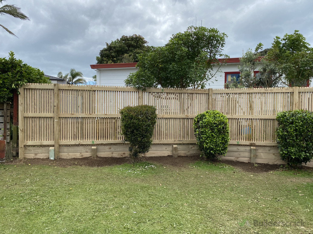 Battened fence over a small retaining wall in Matua