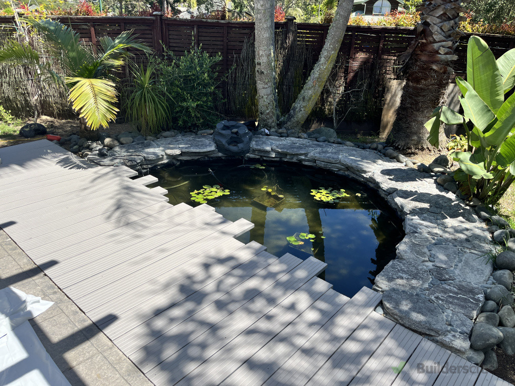 A small garden pond with stonework coping