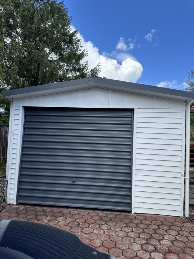 Outdoor Shed - A compact and functional outdoor shed with a modern metallic finish.