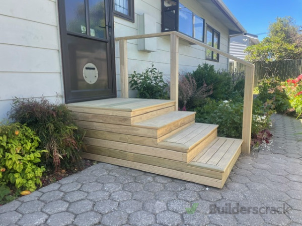 New decking steps over existing concrete with a handrail